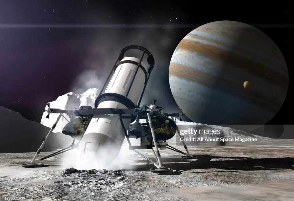 Artist rendering of a NASA drill probe on the icy surface of Europa, one of 79 Jovian moons, created on July 24, 2013. Jupiter and Io, another moon, are visible in the background. (Illustration by Adrian Mann/Future Publishing via Getty Images)